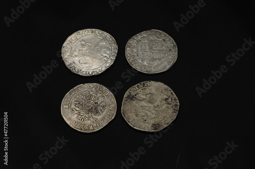 Medieval european silver coins on black background