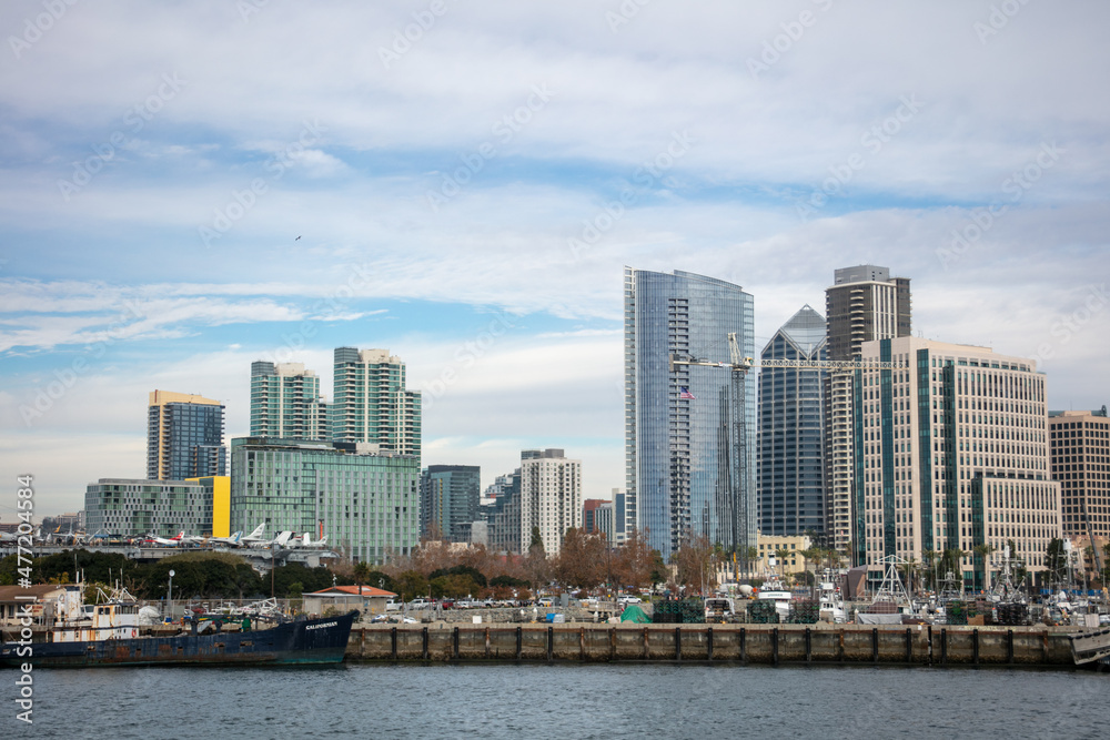 A View of the San Diego Embarcadero Downtown Skyline with One America Plaza Looking at the Skyline and the USS Midway Museum Moored to the Dock
