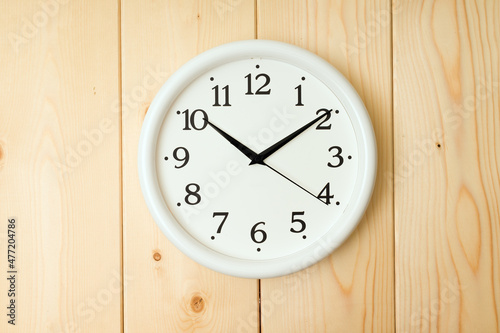 round wall clock on wooden background