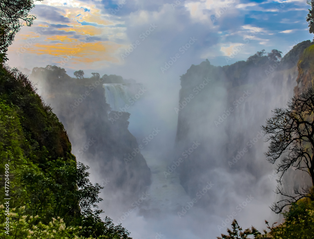 Victoria Falls with water dust and fog in the morning at sunrise Victoria Falls with water dust and fog in the morning at sunrise