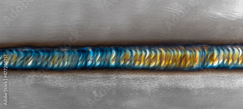 Welding of stainless steel with argon arc welding. Welding TIG. Color welding seam.