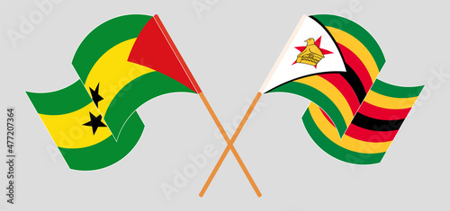 Crossed and waving flags of Sao Tome and Principe and Zimbabwe