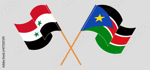 Crossed and waving flags of Syria and South Sudan