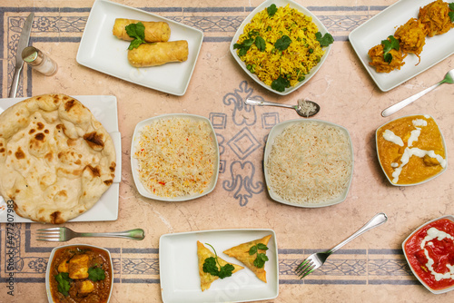 Set of Indian food dishes with various flavors curry, garlic naan, and basmati rice with cheese roll photo