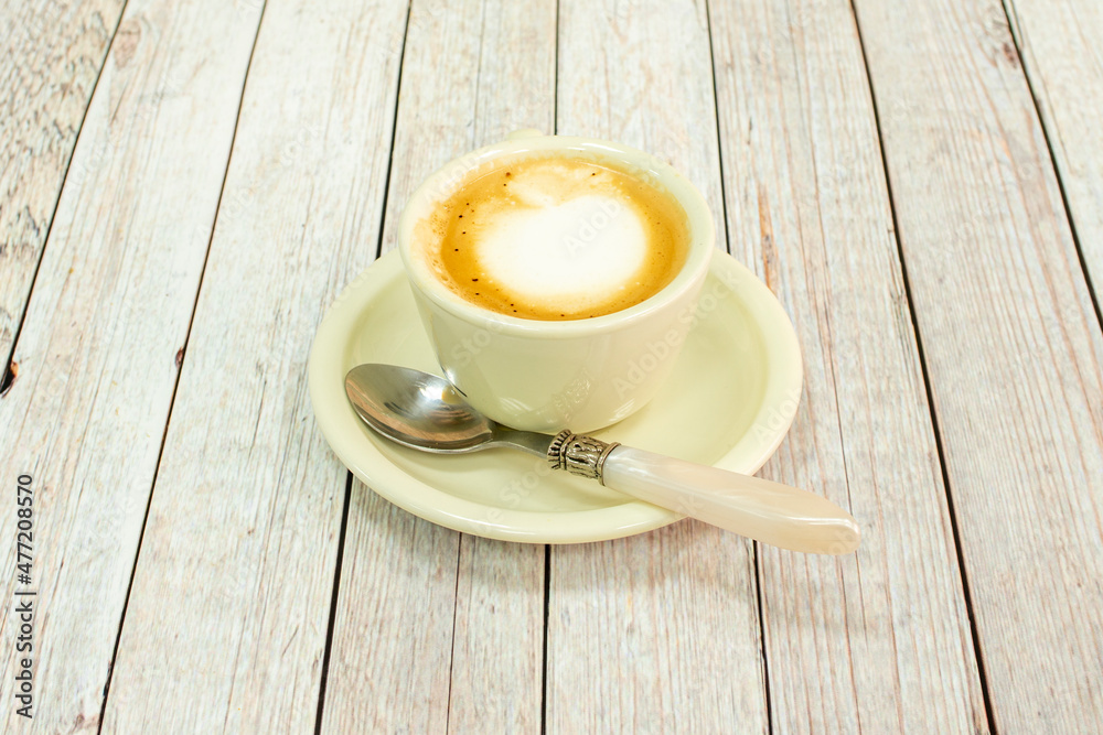 Obraz premium Barista coffee with cream and vintage spoon