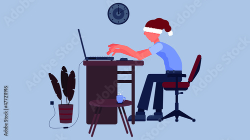 A Young Man In A Christmas Hat Is Working, Or Studying, Or Playing At A Computer In The Office or At Home. Remote Work