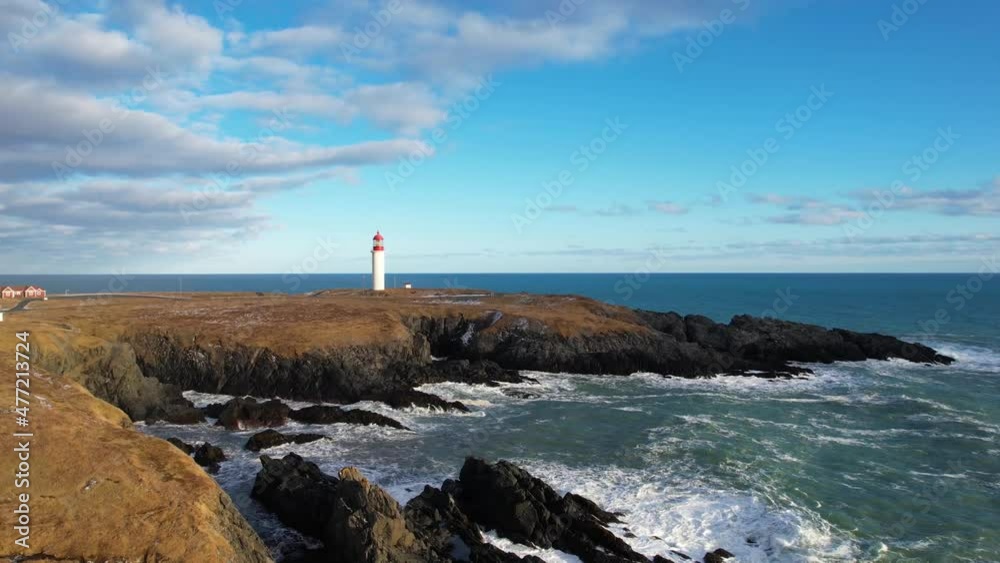 Red and white lighthouse on a beautiful day