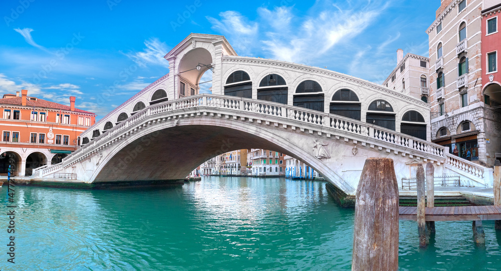 Rialto bridge on The Grand Canal in Venice, Italy. Romantic architecture of Venice on a bright sunny day.