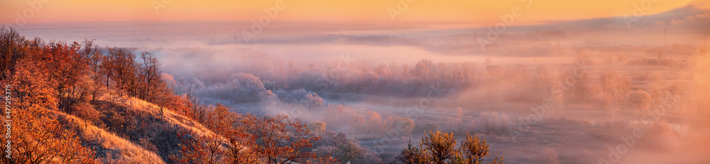 Autumn landscape, background - the morning fog  in the rays of the sun over the river valley, huge panorama, horizontal banner