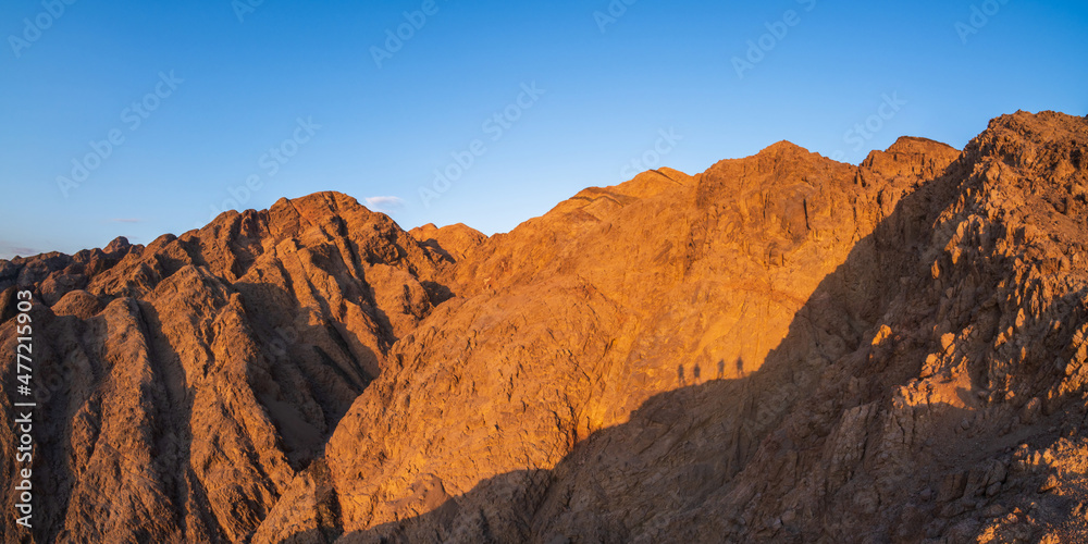 panorama in mountain range at sinai egypt similar to Martian landscapes with shadows of people