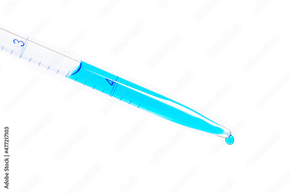 Laboratory pipette filled with blue liquid and resulting chemical solution on Petri dish for a biology experiment in his laboratory. Blue liquid in petri dish. Laboratory concept. Laboratory pipette filled with blue liquid and resulting chemical solution on Petri dish for a biology experiment in his laboratory. Blue liquid in petri dish. Laboratory concept.