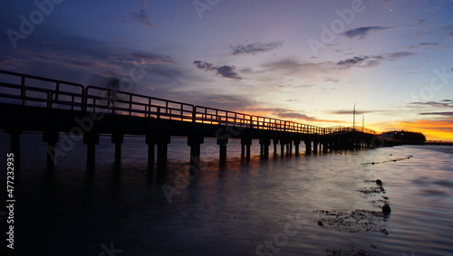 Enjoying the Sunset on the Love Bridge that connects the Big Tidung Island with the Small Tidung. © putra