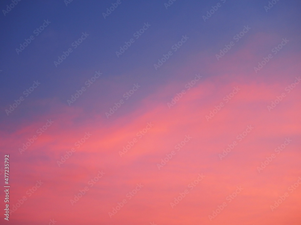 Pastel pink and purple skies and clouds in the evening as the sun sets. The sky is calm and beautiful at dusk, sweet sky.
