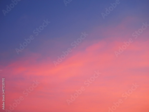 Pastel pink and purple skies and clouds in the evening as the sun sets. The sky is calm and beautiful at dusk, sweet sky.  © Vanchuree