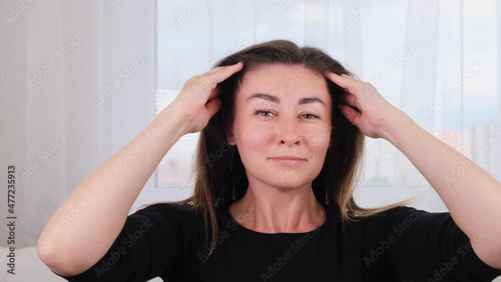 Caucasian woman doing head massage and treating herself. Caring for the soul and body. Manage the stress that comes with the end of the year, give yourself time to restore. Caucasian woman doing head massage and treating herself. Caring for the soul and body. Manage the stress that comes with the end of the year, give yourself time to restore.
