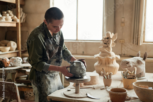 Canvastavla Young sculptor making form from the clay to make beautiful sculptures in worksho