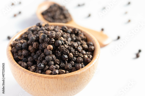 black pepper in a wooden cup