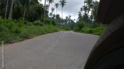 Go pro mounted camera on motorbikes front wheel - 4 K footage from the jungle road on Koh Samui i island in Thailand