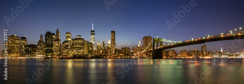 Panoramic view of Manhattan with the Brooklyn Bridge at night. © Xavier