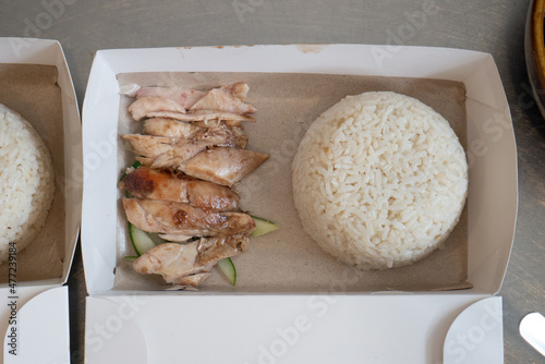 Close up of hainan chicken rice takeaway, served in plastic container