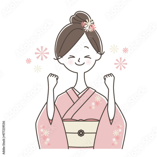 ガッツポーズをする着物姿の女性