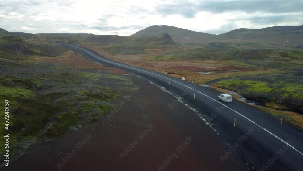 Car driving in distance on country road in Iceland Car driving in distance on country road in Iceland