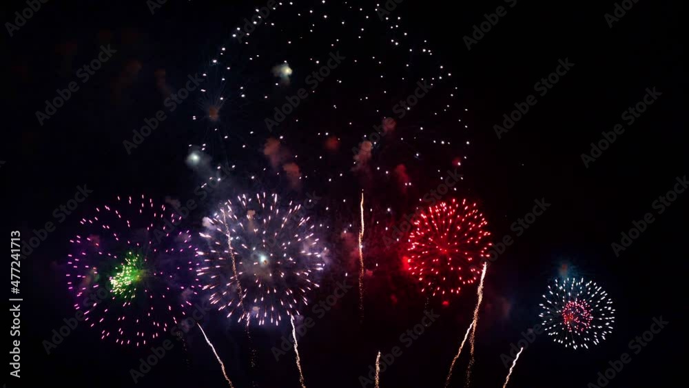 Streaks of white light shoot toward the sky bursting into huge colorful firework displays.