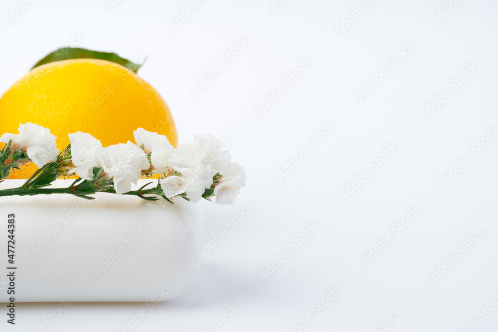 Handmade soap bars and lemon on white background.