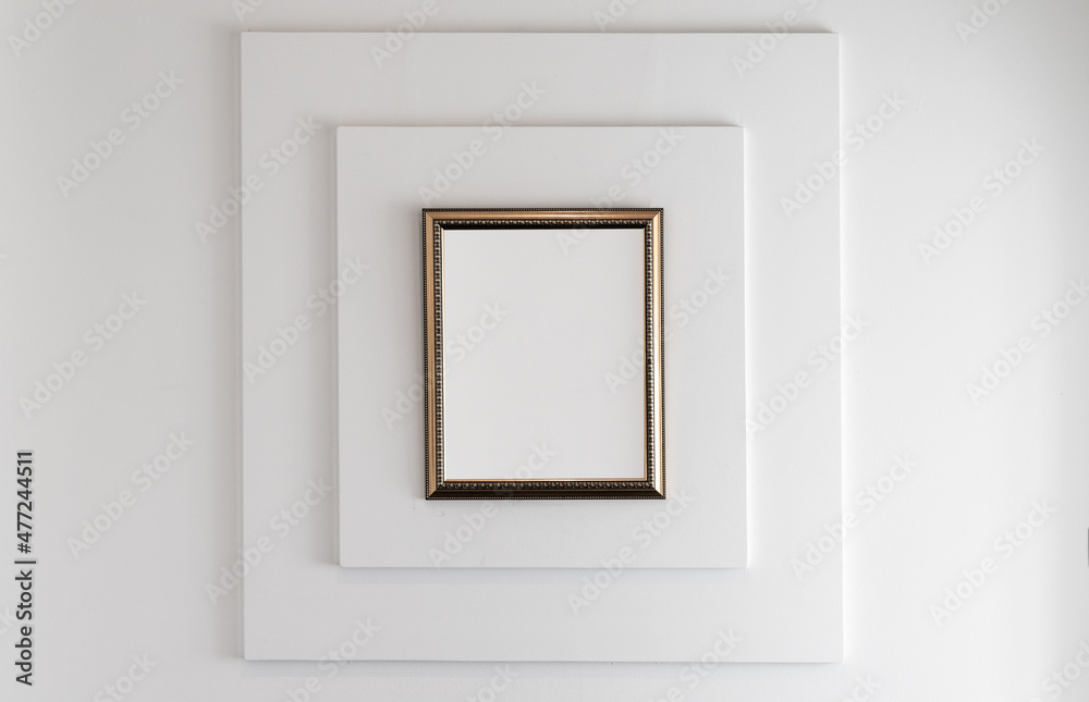 Wooden frame with blank white copy space area on a white wall