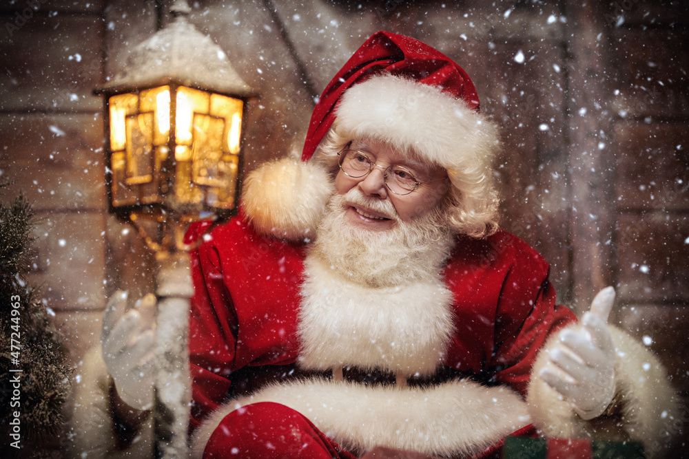 joyful santa looking at lantern