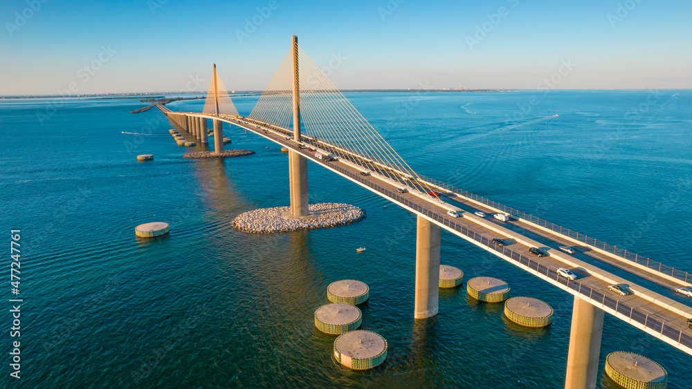 Sunshine Skyway Bridge spanning the Lower Tampa Bay and connecting Terra Ceia to St. Petersburg, Florida, USA. Day photo. Ocean or Gulf of Mexico seascape. Reinforced concrete bridge structure. - obrazy, fototapety, plakaty 