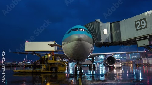 Timelapse of deboarding and servicing arrived plane at night photo