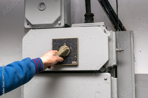 main switch, hand on the lever