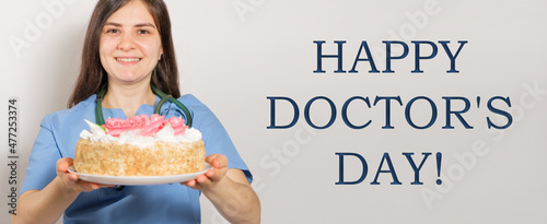 A woman holds a birthday cake, a banner with text Happy Doctors Day photo