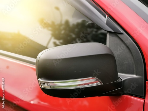 Photo of car rear view mirror with signal lamp and window.