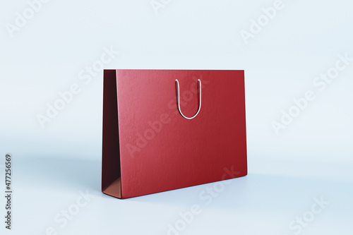 Empty red shopping bag with mock up place on white background. Christmas, present and packaging concept. 3D Rendering.