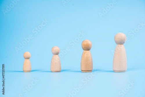 Growing up concepts from kids to adult with  women wooden icon over blue background