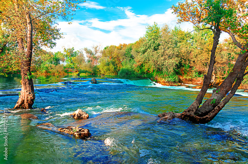 Manavgat Waterfall in Turkey. A beautiful mountain river in the autumn season among the trees.