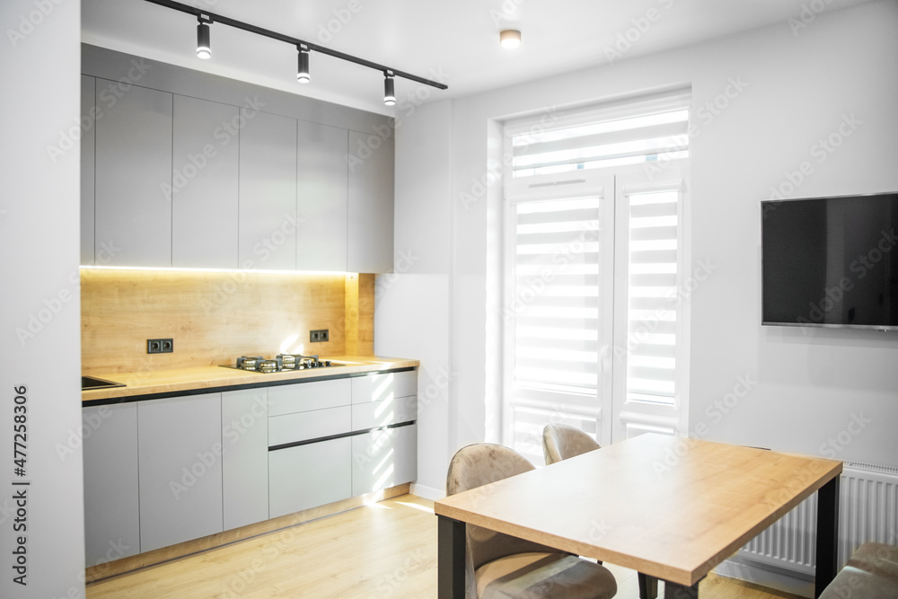 Fototapeta premium Light modern kitchen interior with gray tones. Cozy home.