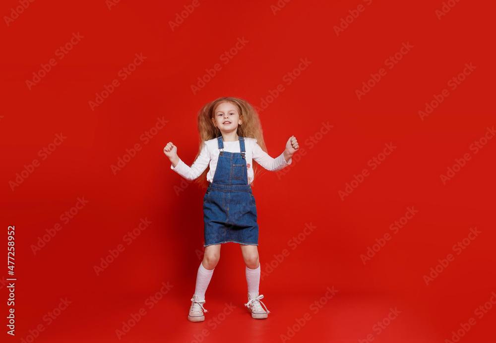full-length attractive, cute, small, cheerful, cheerful girl, jumping, isolated red background full-length attractive, cute, small, cheerful, cheerful girl, jumping, isolated red background