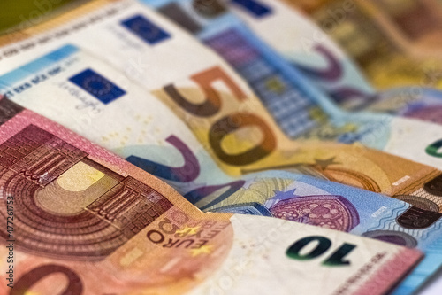 Ten, twenty, fifty euro banknotes as background. Selective focus