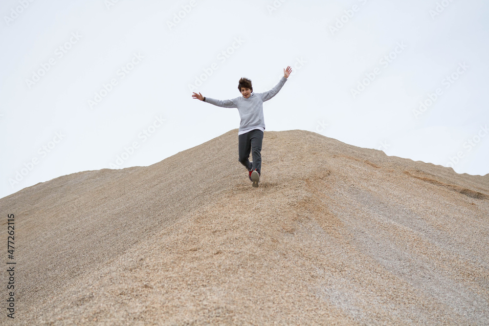A person climbing to the top and achieving happiness A person climbing to the top and achieving happiness
