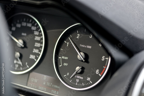 black car tachometer and speedometer dashboard
