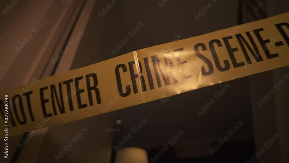 Crime Scene Do Not Enter around a door frame. Police men at a crime ...