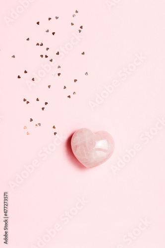 Beautiful heart made of natural rose quartz with sequins. Romantic postcard for February 14. photo