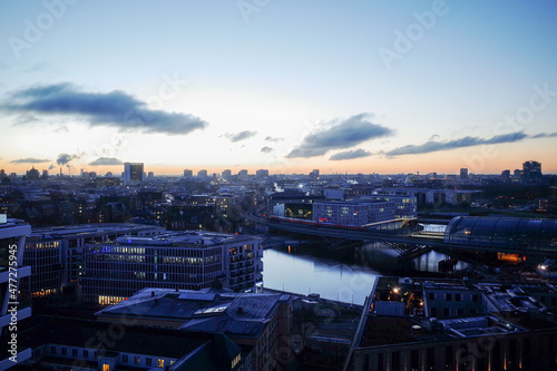 Cityscape view at dawn over Berlin, Germany. Berlin Central Station, government district, Reichstag and river Spree in the background.