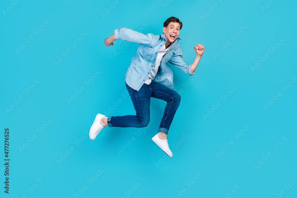 Full size profile side photo of young cheerful man good mood run fast discount isolated over blue color background