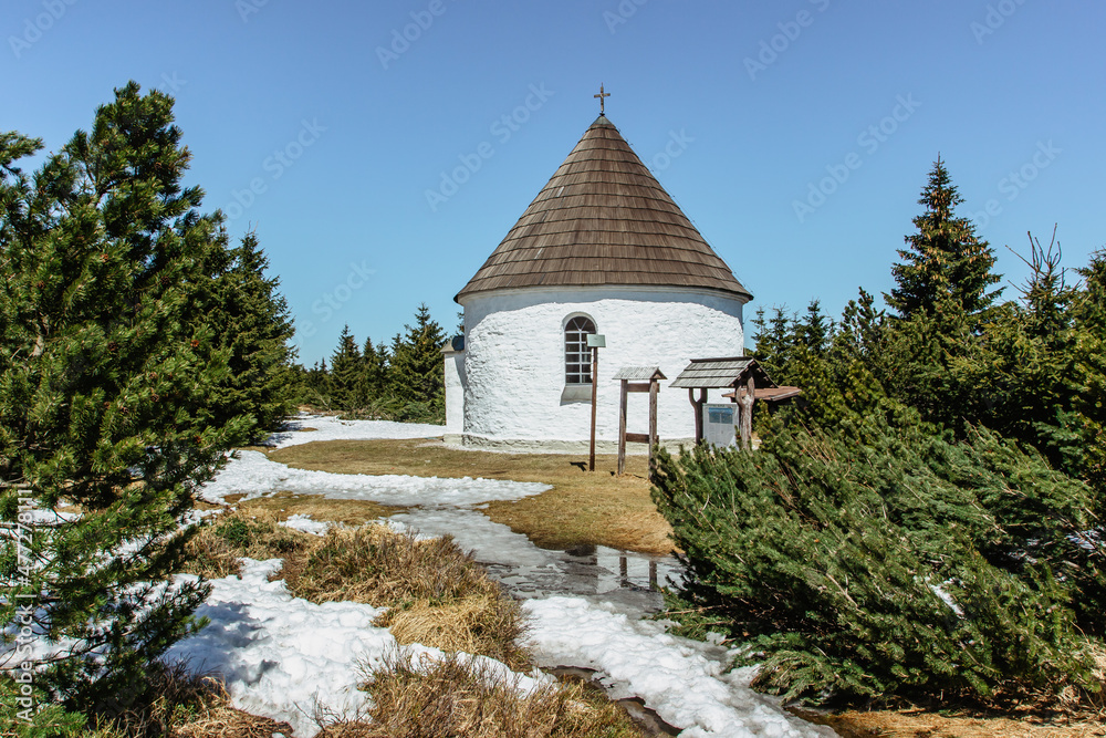 Baroque Chapel of the Visitation of the Virgin Mary,Kunstat Chapel, located in Eagle Mountains at altitude of 1035 m, Czech Republic.Circular floor plan and roof covered with shingles.Sunny day