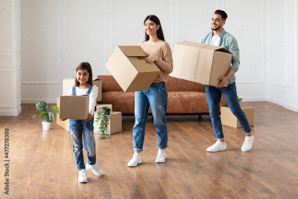 Happy young family holding boxes in new flat Happy young family holding boxes in new flat