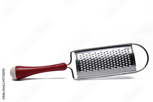 Closeup spice grater red handle white background